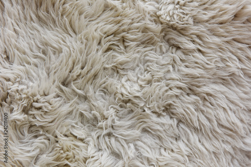 white grey fabric made of faux fur with long nap used for clothing and furniture and bedspreads 