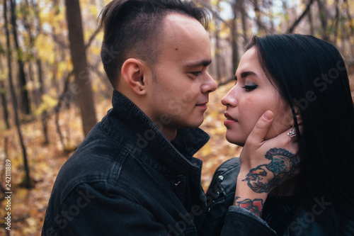 portrait of a young woman and a man walking in the autumn forest