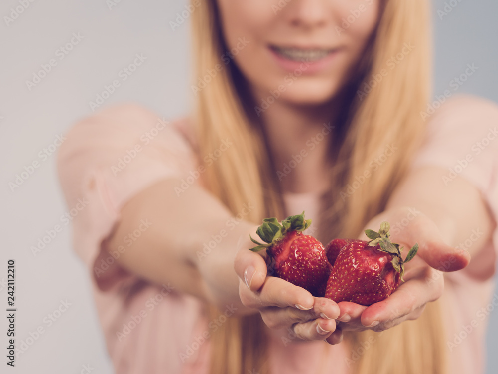 Girl showing fresh strawberries Girl showing fresh strawberries