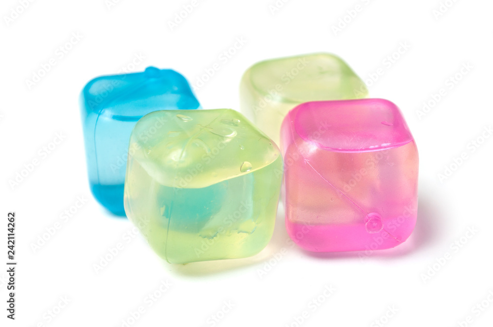 closeup of colorful plastic ice cubes on white background closeup of colorful plastic ice cubes on white background