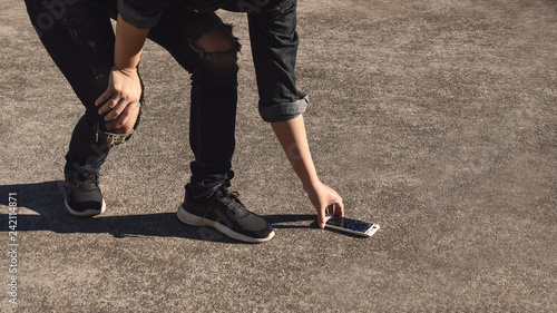Εκτύπωση καμβά Young man picking broken and cracked screen smartphon from floor after dropped with copy space