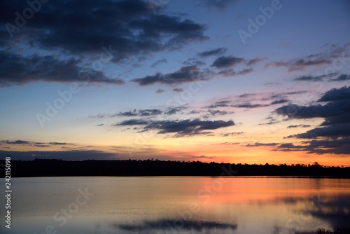 river and mountain landscape on sunset orange background