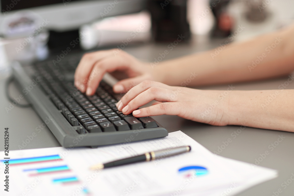 close up. business woman uses computer to check financial report close up. business woman uses computer to check financial report