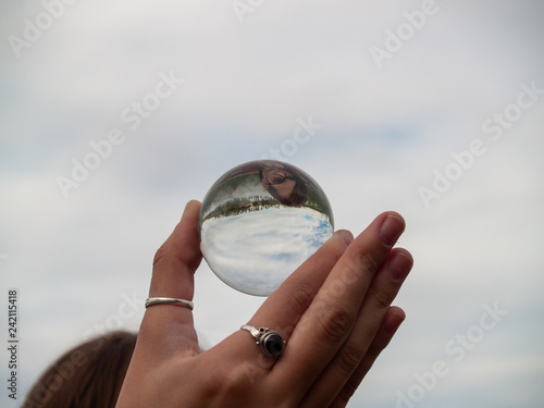A teenage woman with a crystal ball in her hand