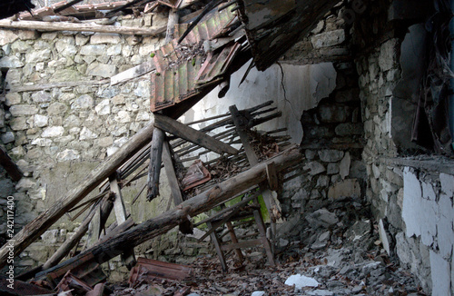 Collapsed wooden roof of old stone building
