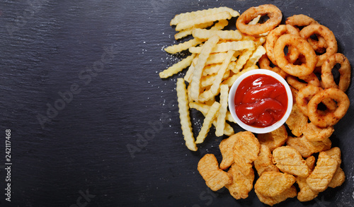 fast food products: onion rings, french fries and chicken nuggets