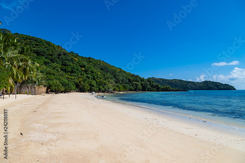 Amazing tropical beach on the Bulalacao island. Beautiful tropical island with white sand and palm trees. Palawan, Philippines.