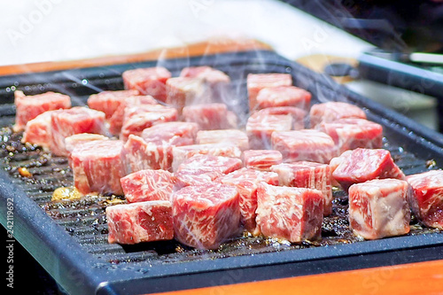 Cooking diced steak on iron hot plate. Grilling diced beef. Grill Meat Steak Barbecue.