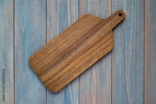 Walnut wood cutting board on a wooden gray background