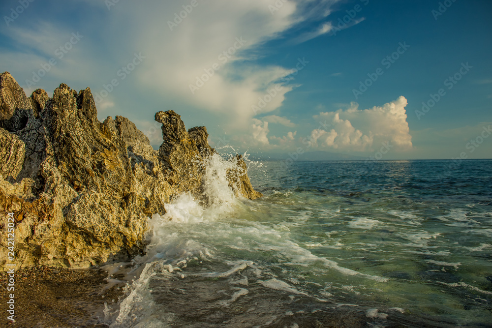 Aegean sea landscape rocky beach shoreline and waves breaks on stone Aegean sea landscape rocky beach shoreline and waves breaks on stone