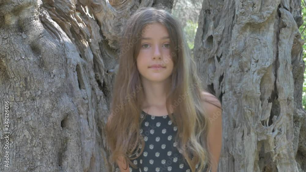 A girl in an olive grove. Tree trunk A girl in an olive grove. Tree trunk