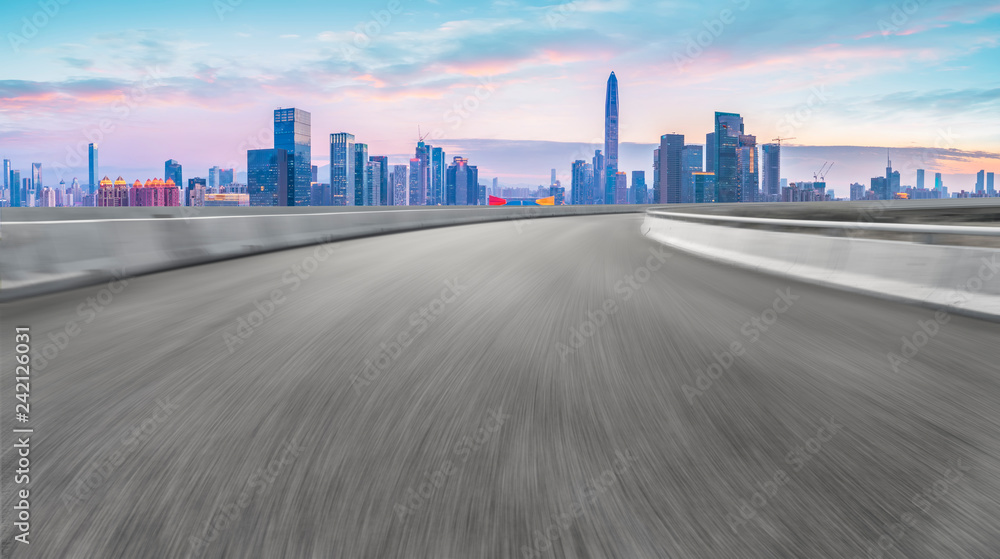 Empty asphalt road along modern commercial buildings in China,s cities Empty asphalt road along modern commercial buildings in China,s cities
