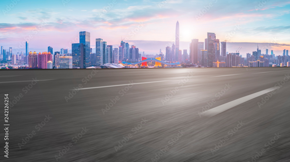 Empty asphalt road along modern commercial buildings in China,s cities Empty asphalt road along modern commercial buildings in China,s cities