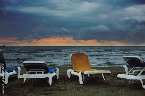 Blue and yellow sun loungers on the background of the sea at sunset. Landscape. Shooting in daylight. Author's retouch © Nadiia