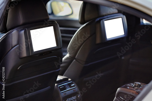 Car inside headrest screen mock up. Two white displays for back seats passenger with media control panel copy space and place for text