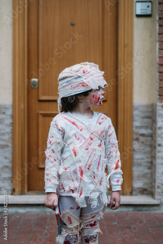 Little boy dressed in mummy in the street