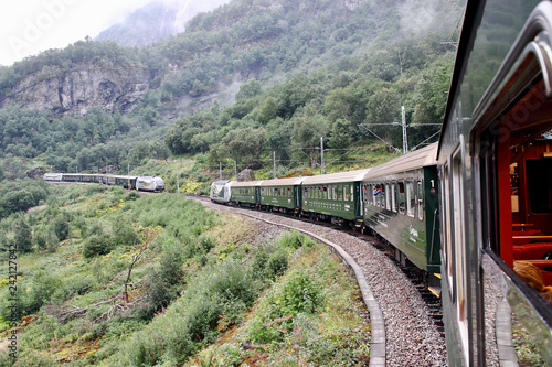 Famous Norwegian Flamsbana train going uphill on its way to Myrdal station and crossing with another one going downhill. This railroad track is said to be one of the most beautiful ones on earth.