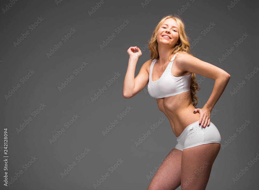 Young beautiful blonde woman in white fitness clothing Young beautiful blonde woman in white fitness clothing
