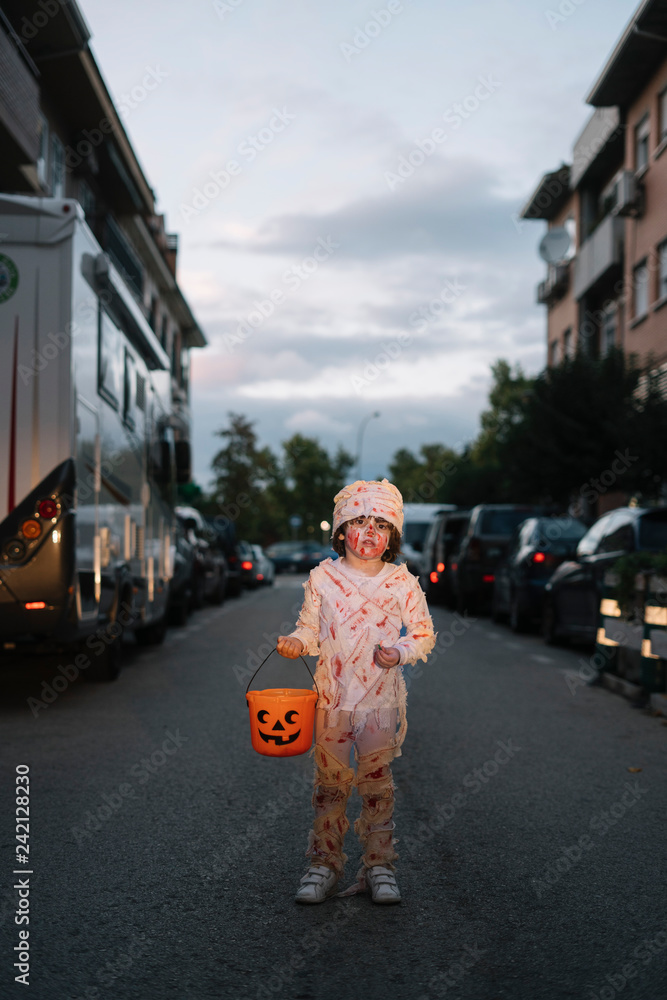 Obraz premium Little boy dressed in mummy in the street