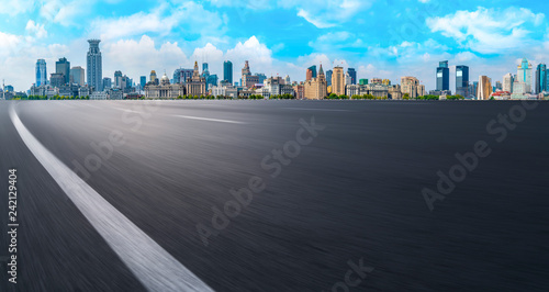 Empty asphalt road along modern commercial buildings in China s cities