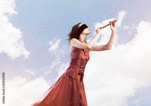 Girl playing her melody on fife at summer bright day