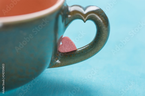 Small Pink Red Heart Shape Sugar Candy on the Handle of Coffee
