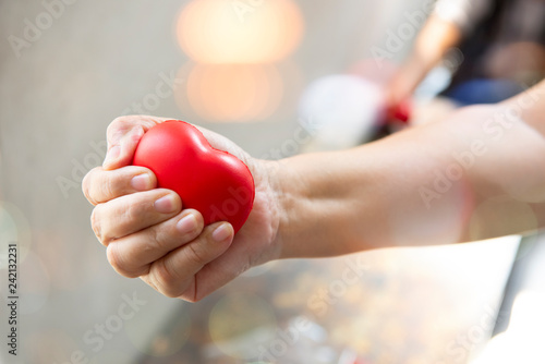 hands holding red heart, health care, donate and family insurance concept, world heart day