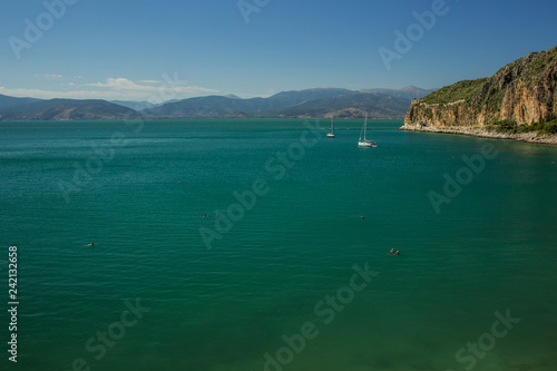 summer vacation concept on Mediterranean scenic landscape view with sea bay surrounded by mountains and cruise ships in calm vivid color water surface 