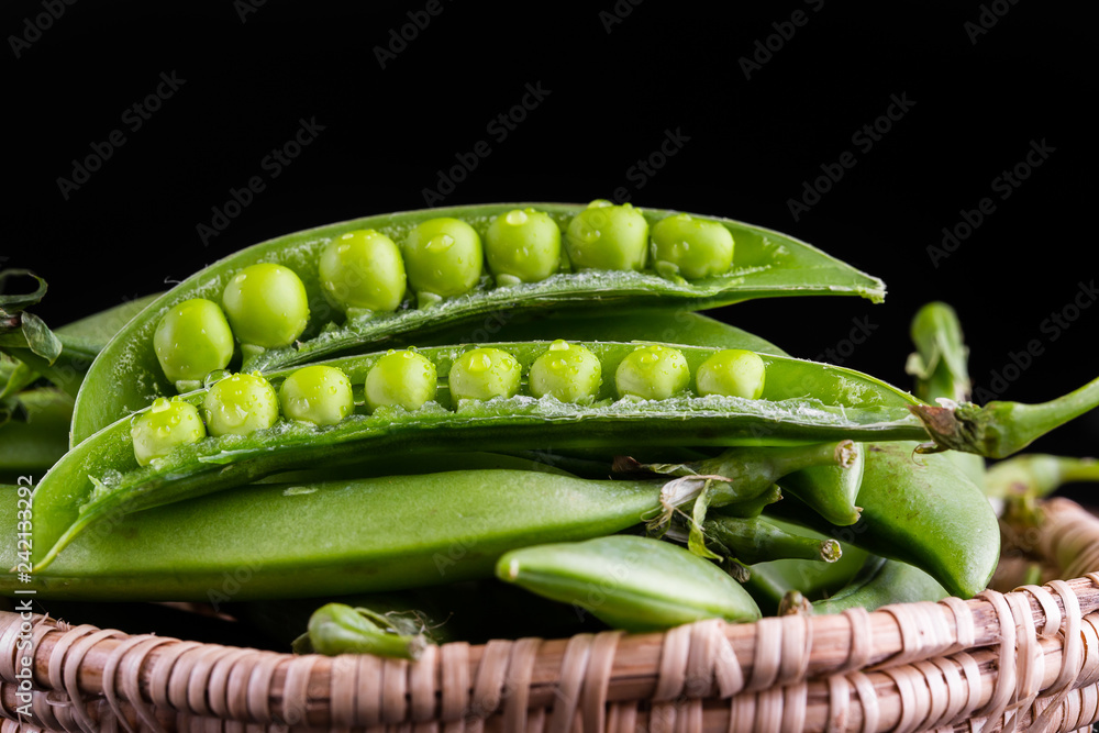Sugar snap peas with mint on a rustic wood background Sugar snap peas with mint on a rustic wood background