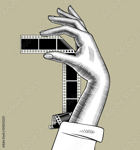 Female palm hand holding a camera roll