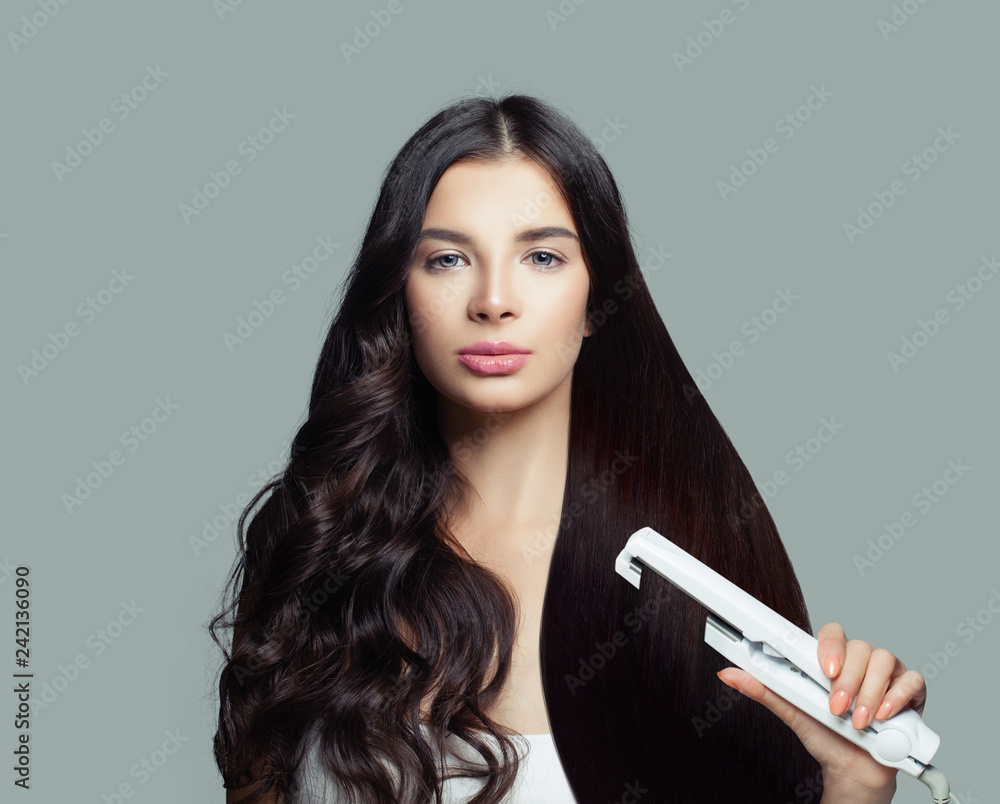 Glamorous woman with long healthy straight hair and curly hair using hair  straightener. Cute girl straightening healthy hair with flat iron. Hair  care concept Stock Photo | Adobe Stock