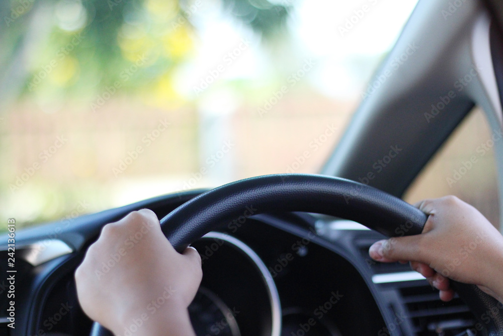 Both hands are holding the steering wheel of the car Both hands are holding the steering wheel of the car