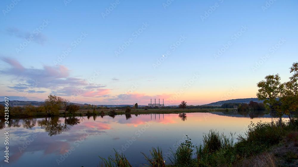 Panoramic View Of A Lake At Sunset With A Coal Power Station In