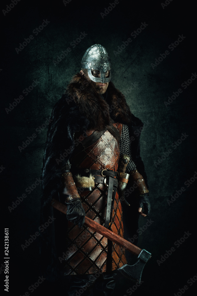 Naklejka premium Portrait of a Viking holding an ax in his hand