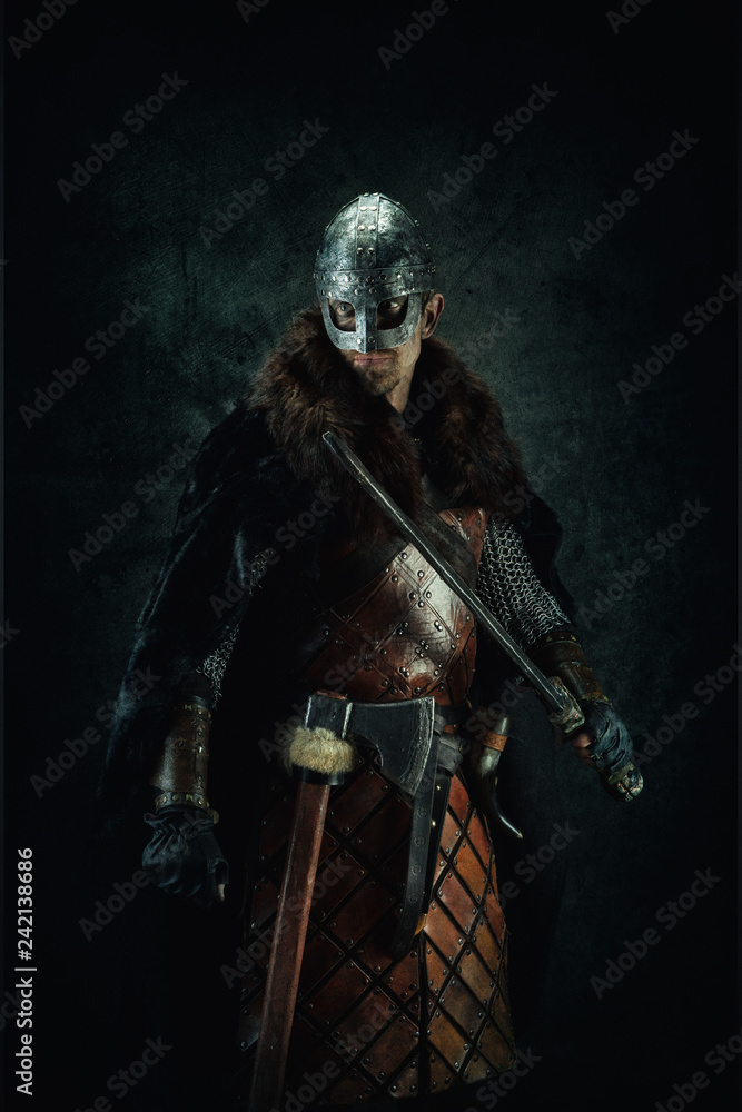 Portrait of a Viking holding a sword in his hand Portrait of a Viking holding a sword in his hand