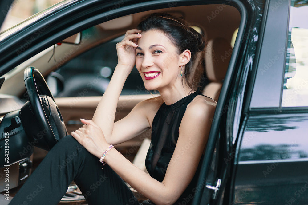 Gorgeous woman laughing, happy while sitting on the front seat i Gorgeous woman laughing, happy while sitting on the front seat i