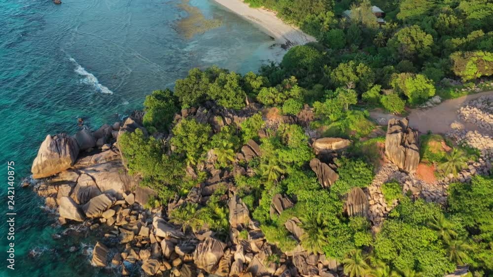 Aerial view of tropical paradise beach Anse Severe at sunset, crystal clear water of Indian Ocean - La Digue Island, Seychelles Islands from above Aerial view of tropical paradise beach Anse Severe at sunset, crystal clear water of Indian Ocean - La Digue Island, Seychelles Islands from above