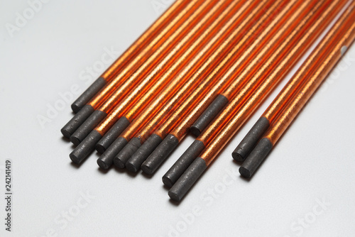 copper coated carbon electrodes for copper and bronze welding. on a uniform light background photo