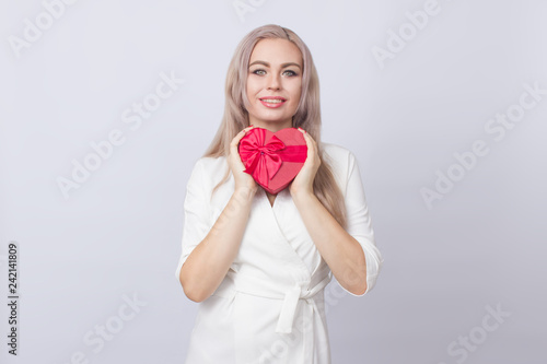 Blonde woman with gift red heart box