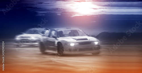 Blurred two drifting cars battle on speed track, sport concept