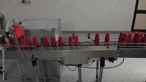 Tomato sauce on machinery conveyor belt. Tomato sauce production sequence photo