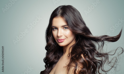 Young beautiful woman with long blowing hair. Hair care and beauty salon background