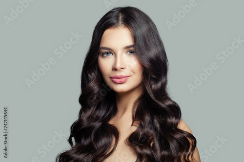 Cute woman with healthy hair. Curly hair, haircare concept