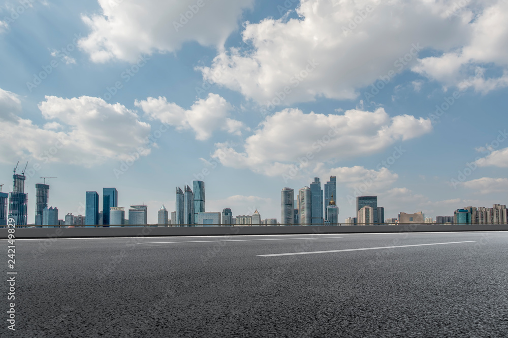 Empty asphalt road along modern commercial buildings in China,s cities Empty asphalt road along modern commercial buildings in China,s cities