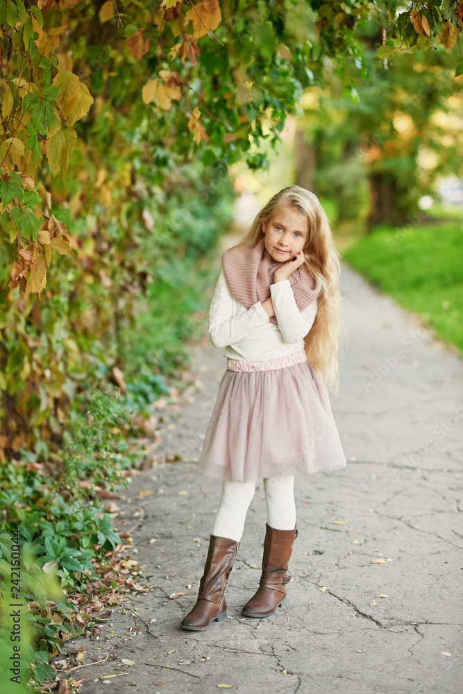 Happy little child, baby girl playing in autumn on nature walk outdoors. Autumn background. Family walk in park. School time. childhood happiness. Fall season. Happy little child, baby girl playing in autumn on nature walk outdoors. Autumn background. Family walk in park. School time. childhood happiness. Fall season.