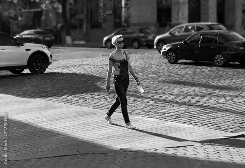 woman crosses the street at a pedestrian crossing