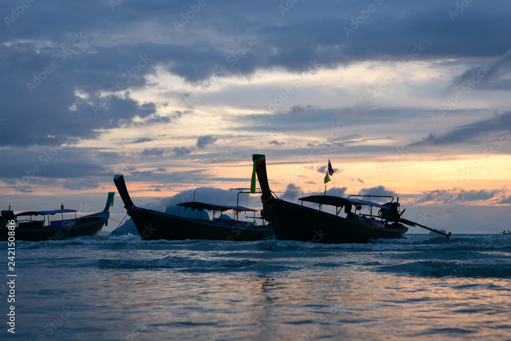 Traditional thai boats at sunset beach.