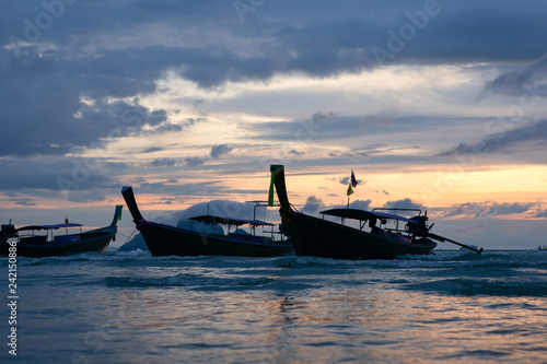 Traditional thai boats at sunset beach.