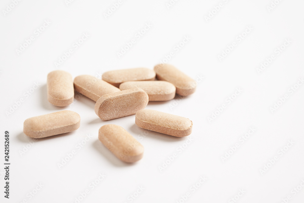 Rhodiola rosea. Golden root, rose root. Herbal pills with healthy medical plant. Healthy supplement on white background. Close up. Rhodiola rosea. Golden root, rose root. Herbal pills with healthy medical plant. Healthy supplement on white background. Close up.