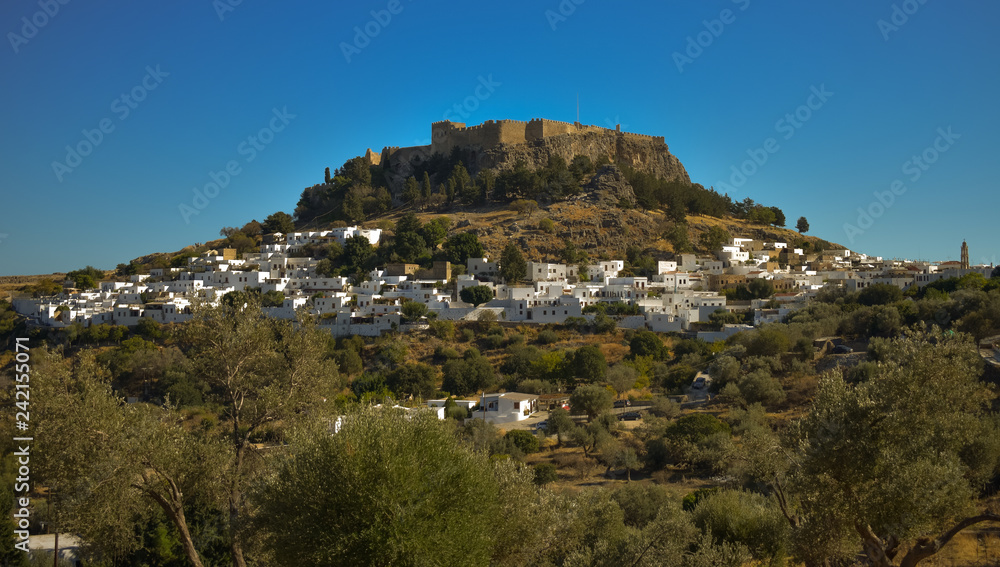 LINDOS,RHODES/GREECE OCTOBER 29 2018 : The Acropolis  and the village of Lindos photo taken from Kleovoulos Tomb hill